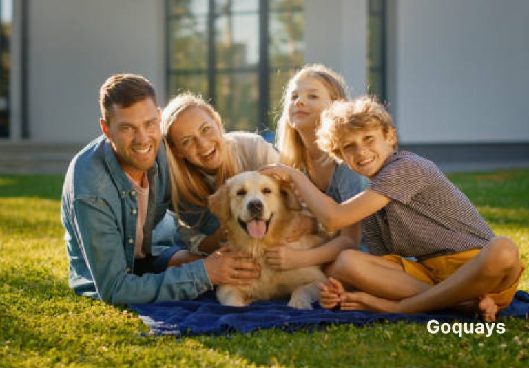 A happy family with young children playing in the backyard with a friendly-looking dog