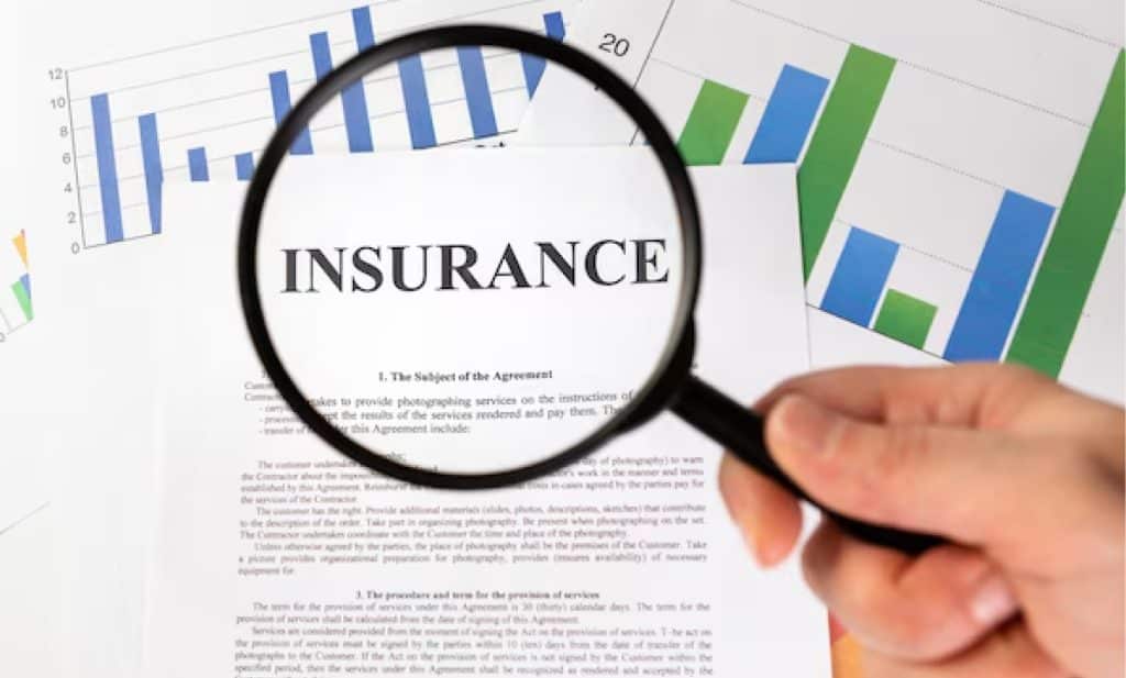 magnifying glass highlighting exclusions in a cheap travel insurance policy